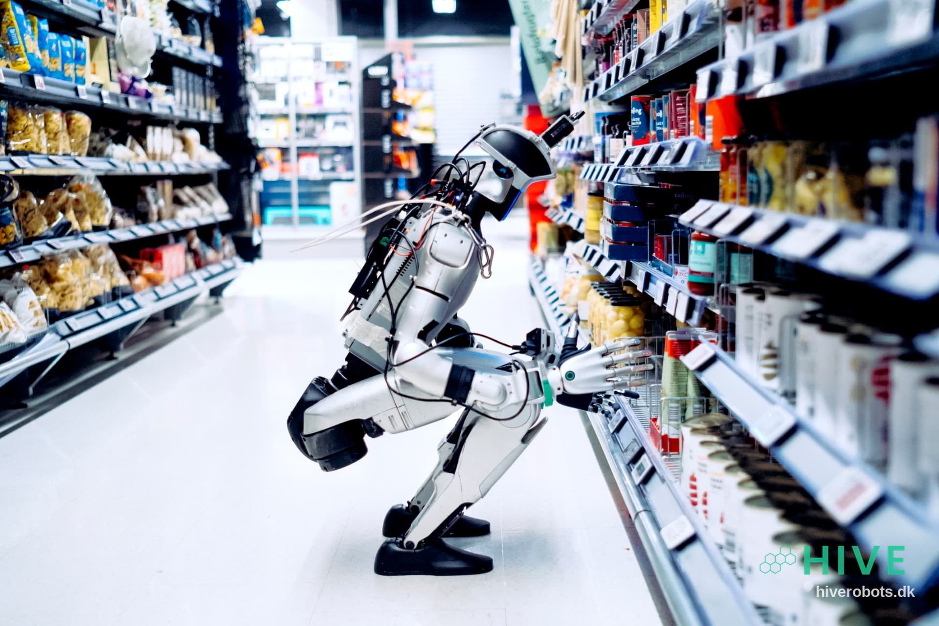 HIVE humanoid robot restocking a supermarket shelf